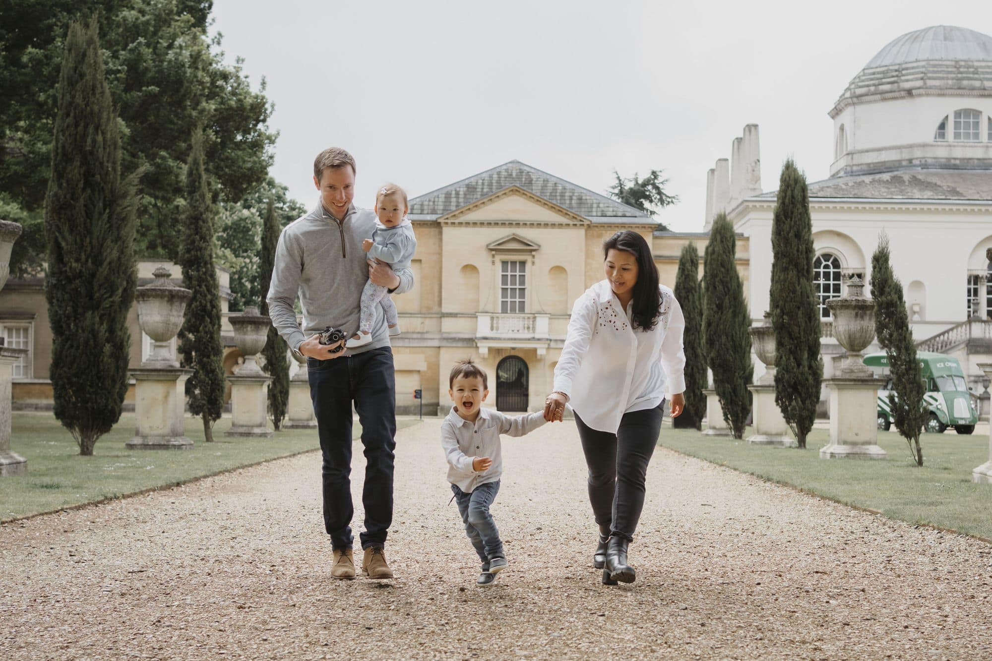LONDON FAMILY PHOTOGRAPHY SESSION of family running down path at chiswick house
