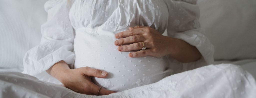 pregnant woman in white dress. maternity hospital bag