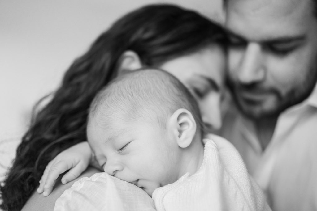 parents with newborn baby in black and white photgraph