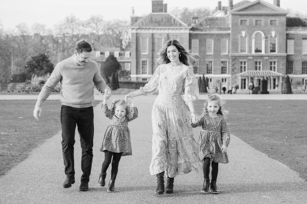 image of family walking in front of kensington palace taken by london vacation photographer