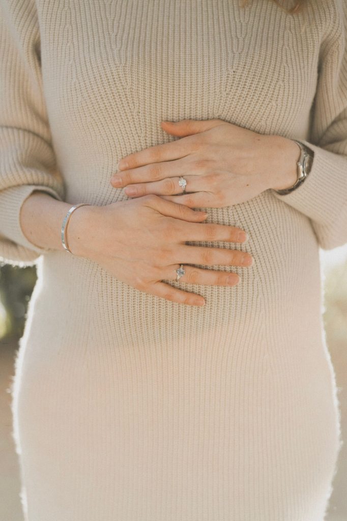 image of pregnant woman with hands on her belly taken by london maternity photographer