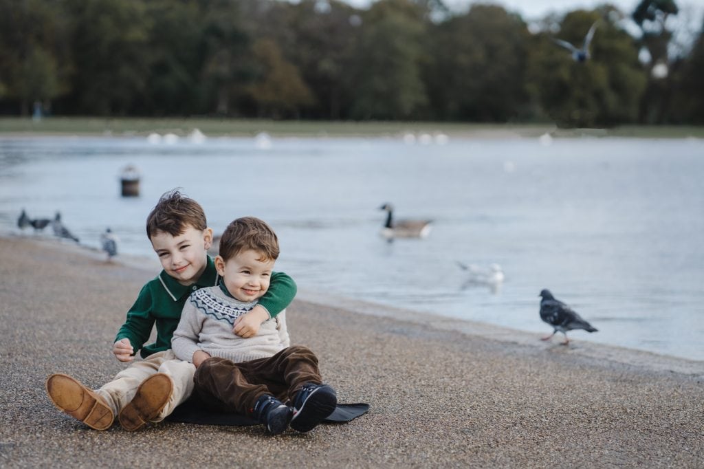 two boys by the pond in kensington gardens