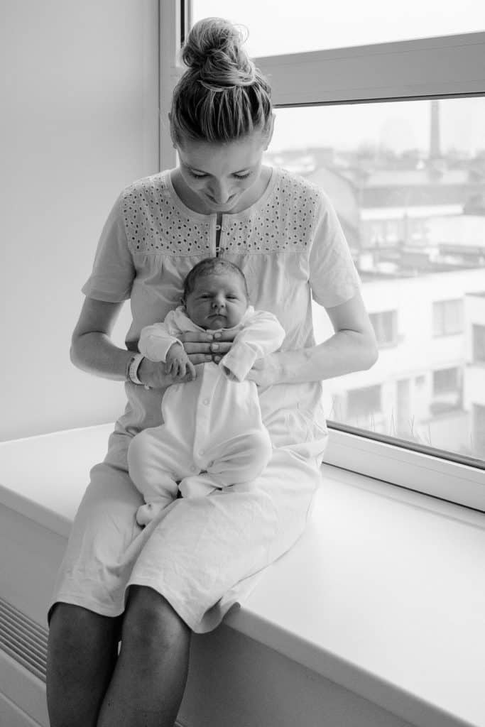 fresh 48 newborn photo in hospital london of mother looking at her newborn baby